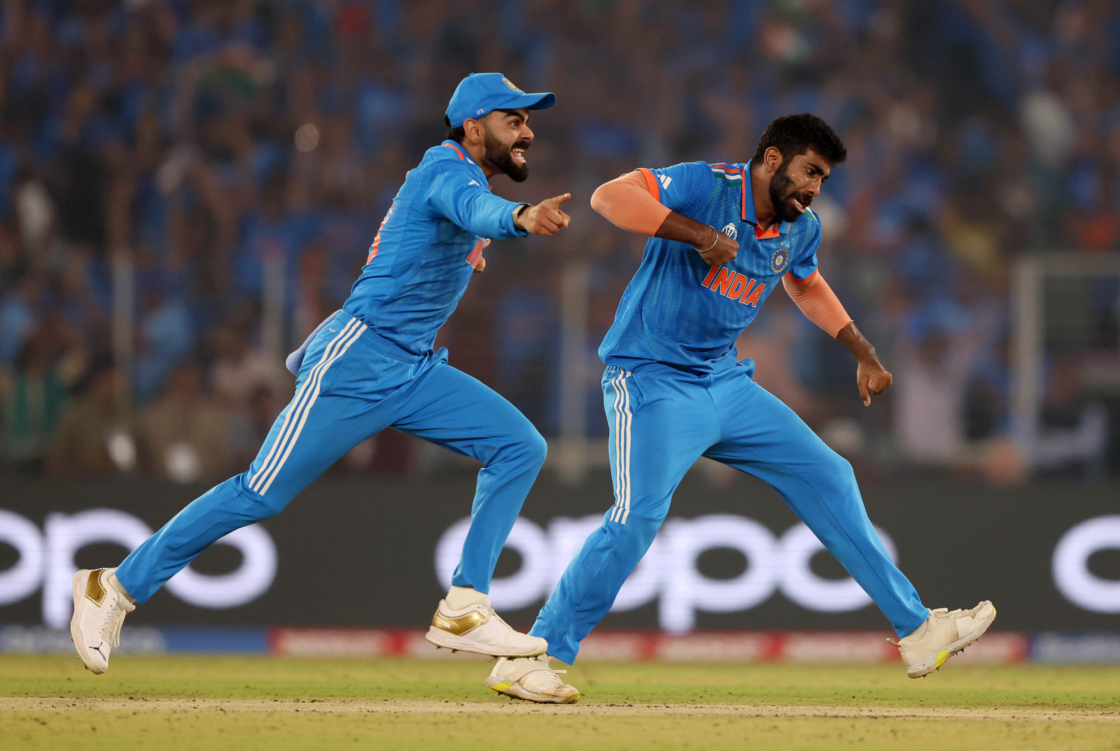 India's Jasprit Bumrah celebrating Steve Smith's wicket with Virat Kohli during the ICC 2023 ODI World Cup final in Ahmedabad