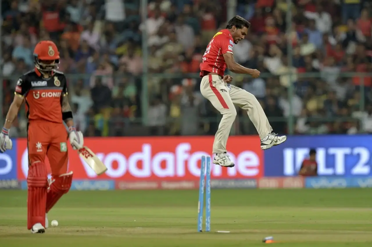 Kings XI Punjab's Sandeep Sharma celebrating Virat Kohli's wicket