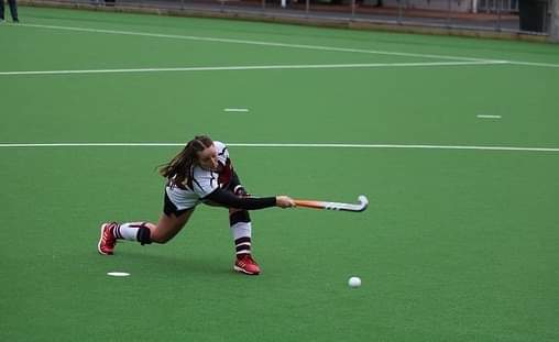 Izzy Gaze playing hockey during her formative days